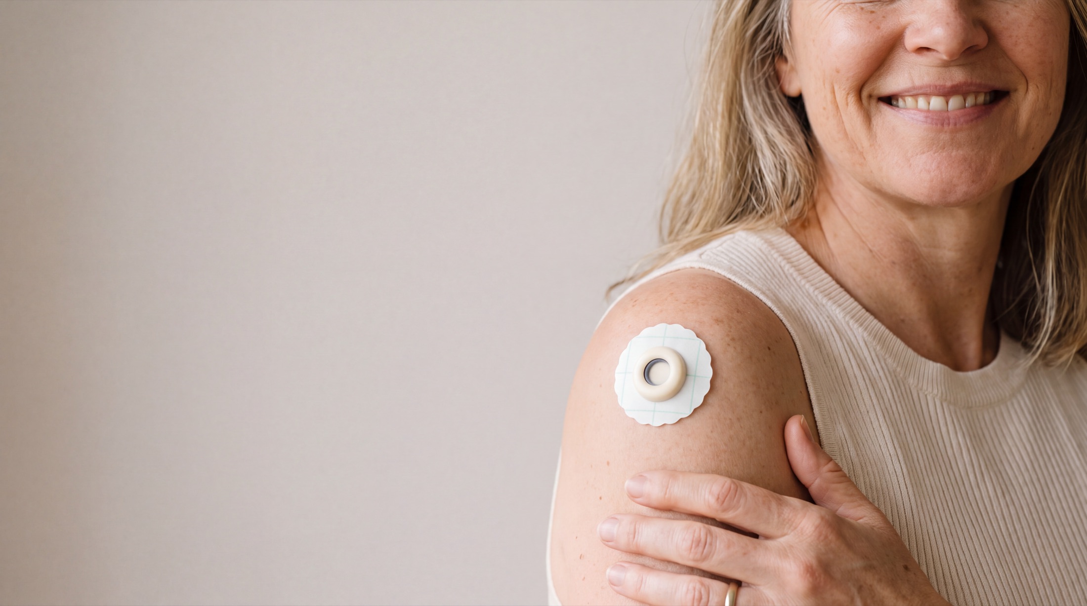 A woman wearing the Themis slow-release patch on her shoulder